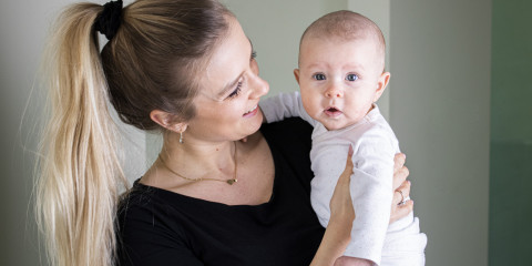 Jonge mama met baby in haar armen