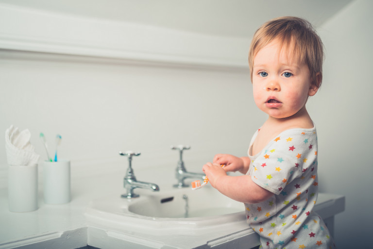 Peuter poetst tanden in badkamer