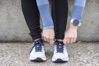 une femme chausse ses chaussures pour aller faire du sport